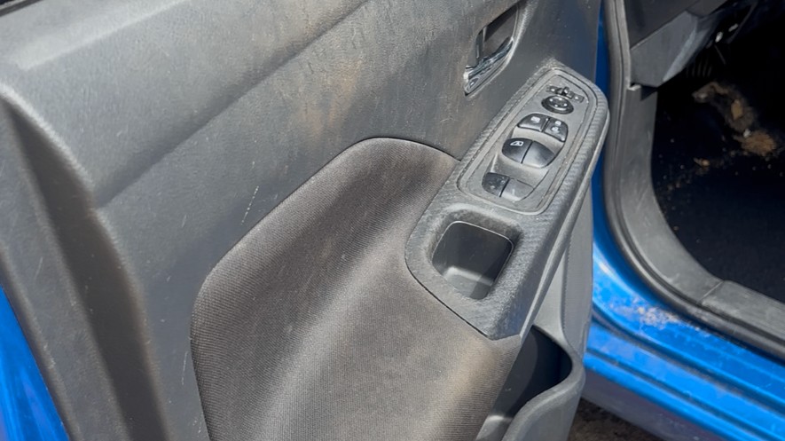 Same door panel before detailing — visible dust and grime